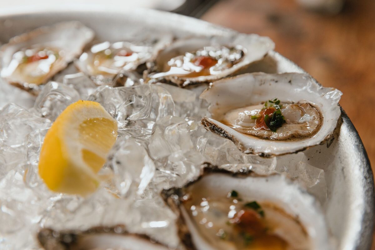 Fresh oysters on crushed ice with a lemon wedge