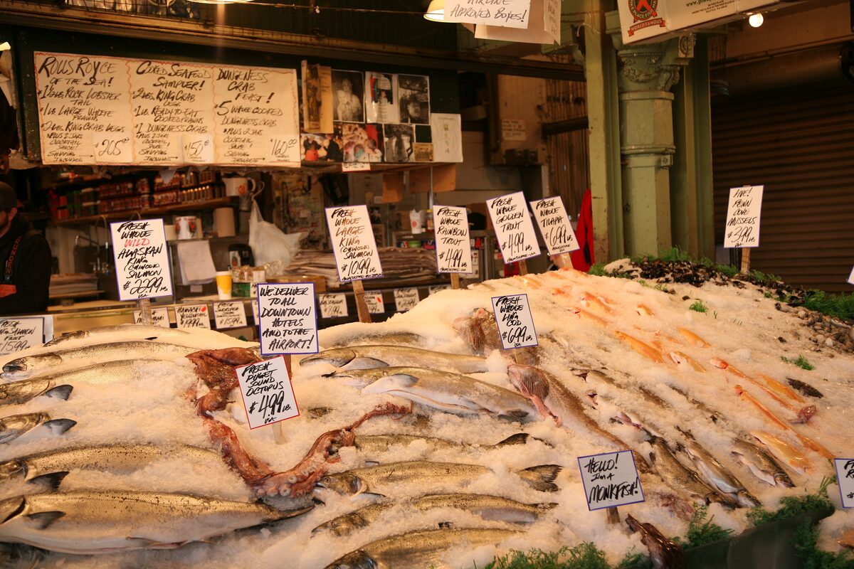 Fresh salmon fillets on ice at a Pike Place fish stall