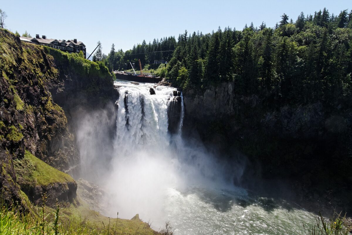 Snoqualmie Falls plunging into a misty gorge ringed by forest