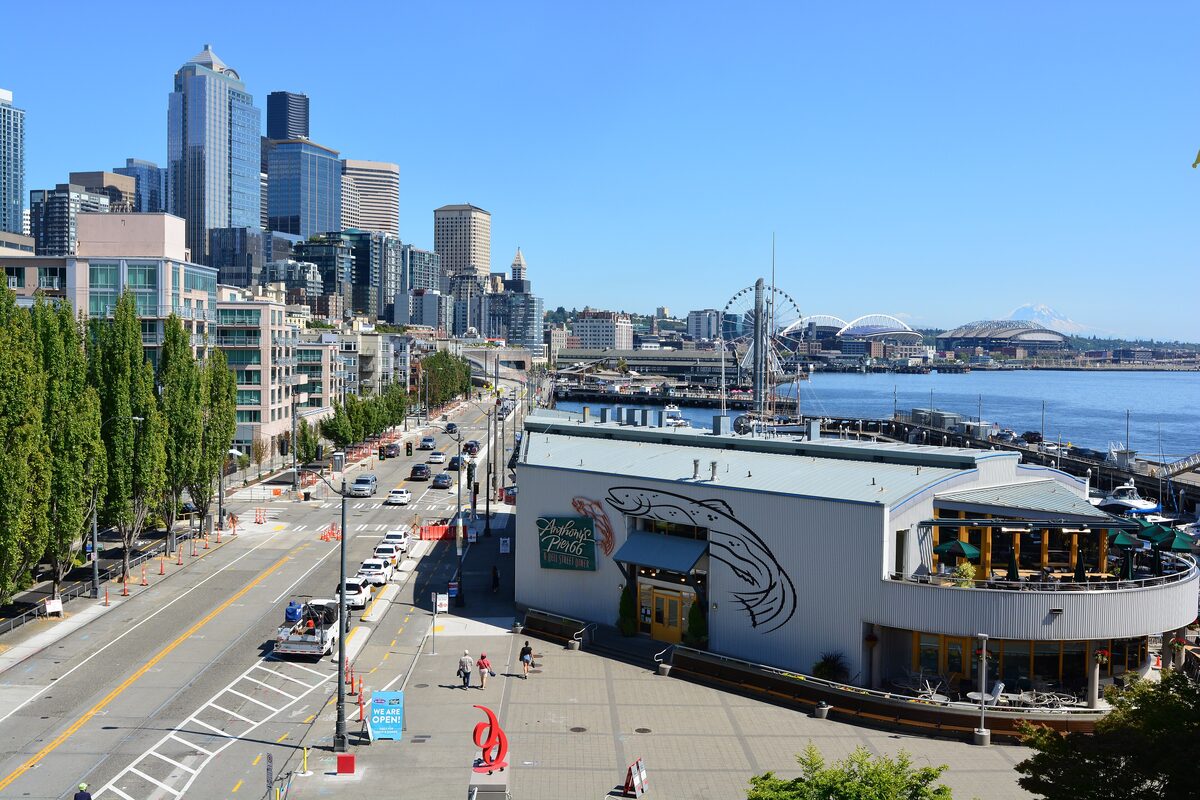 Seattle's waterfront piers and downtown skyline seen from a footbridge