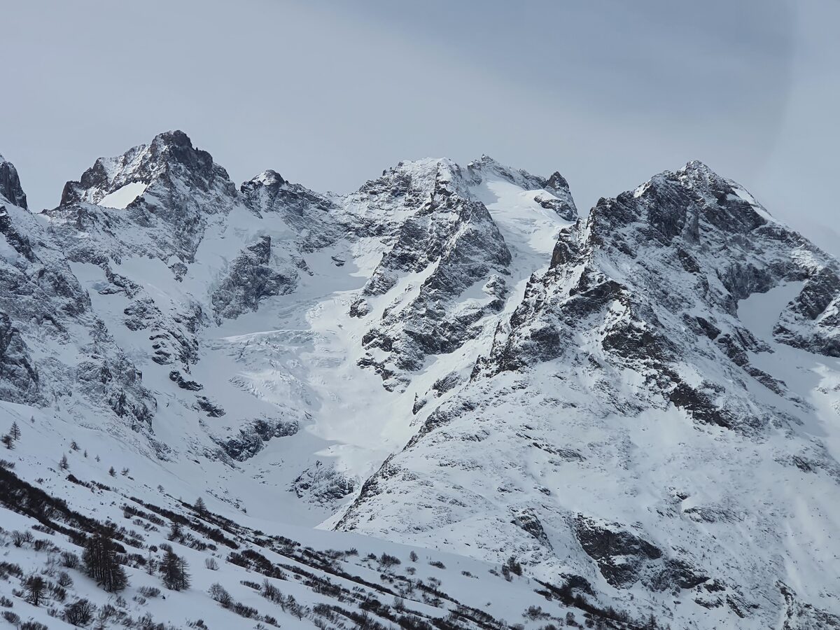 Snow-covered peaks of the Meije massif seen from the Lautaret pass road
