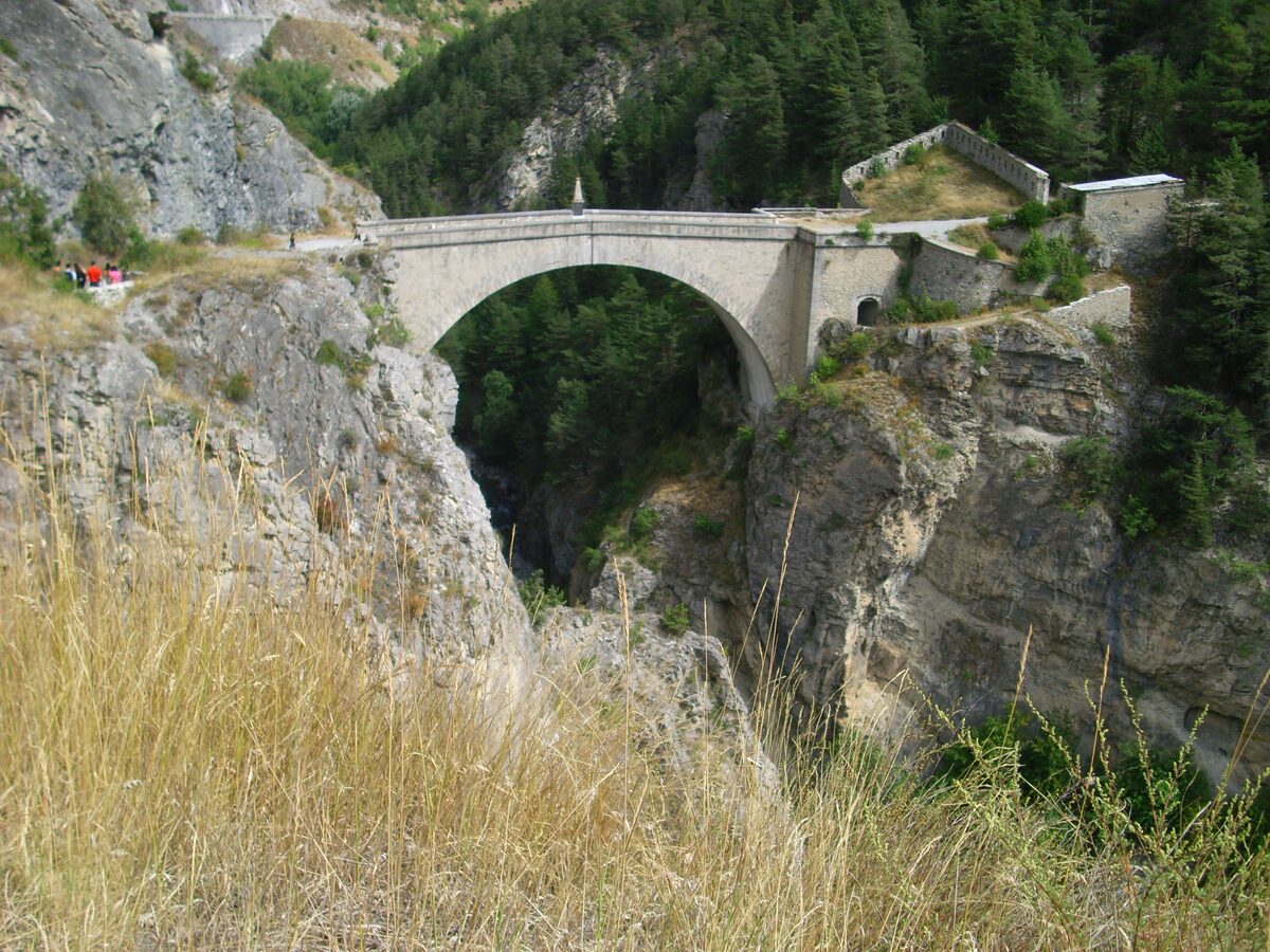 The Pont d'Asfeld, a stone arch bridge across a wooded gorge with a fortification on the rock above