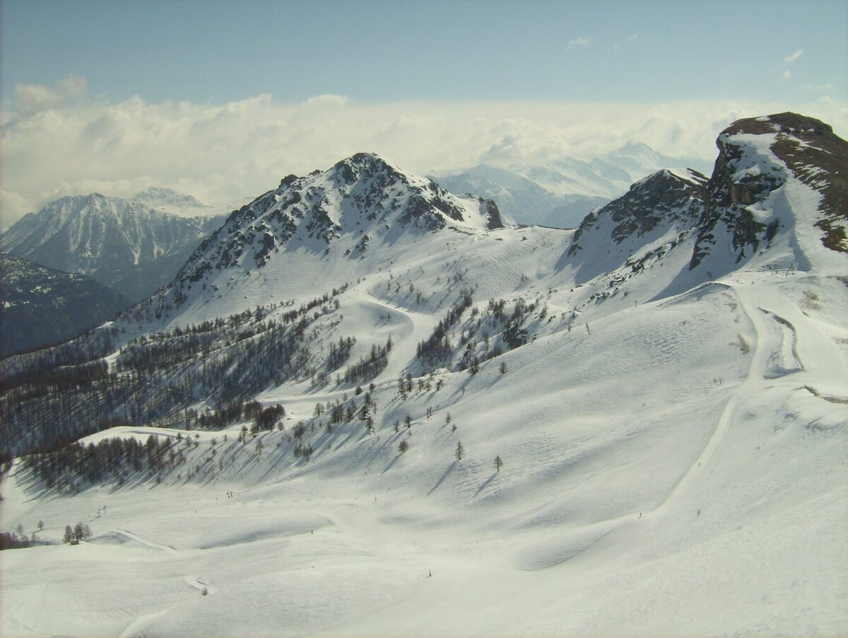 Snow-covered peaks and piste lines on the mountain above the Prorel sector