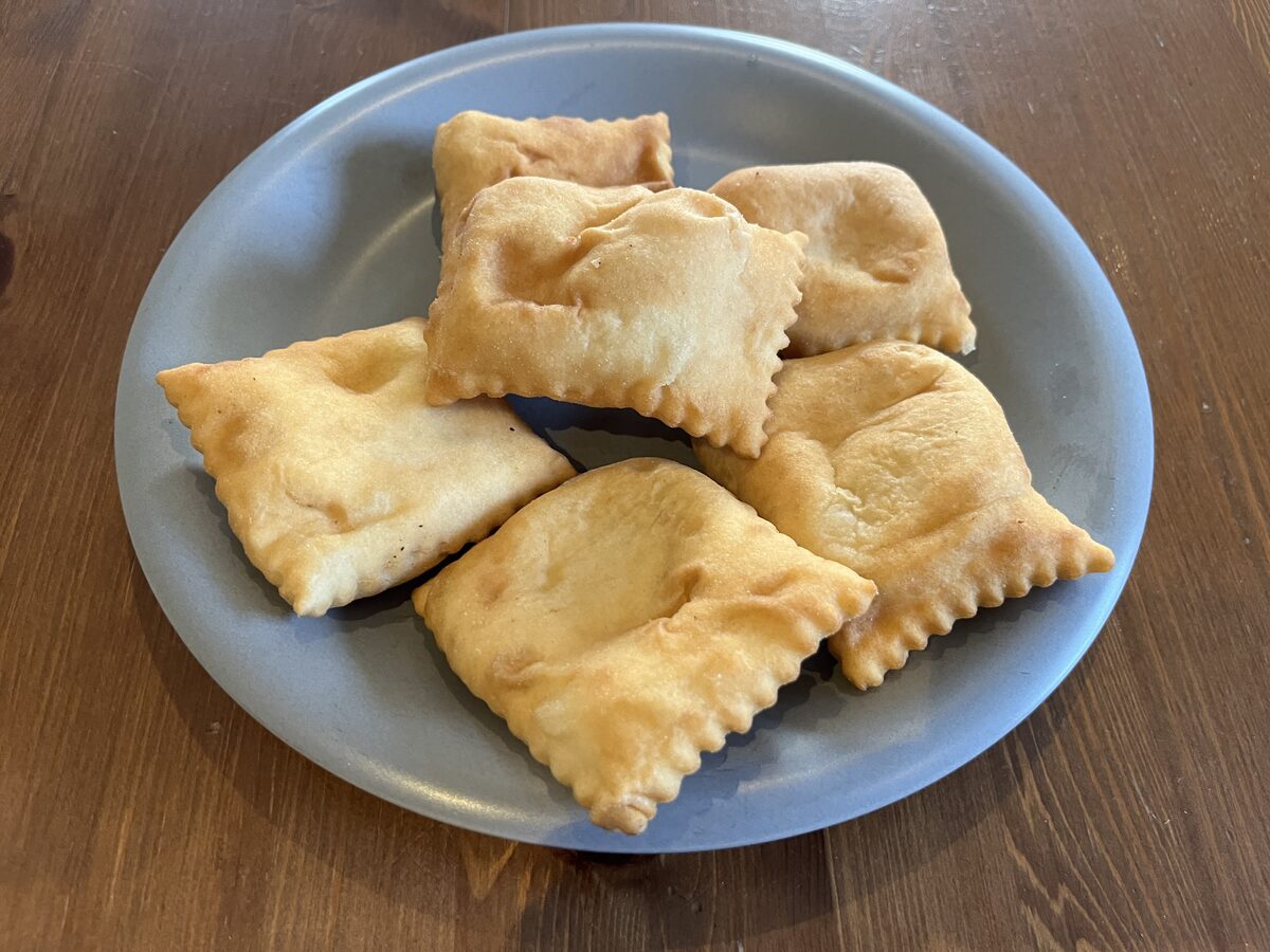 A plate of tourtons, small savoury pastries folded and crimped at the edges
