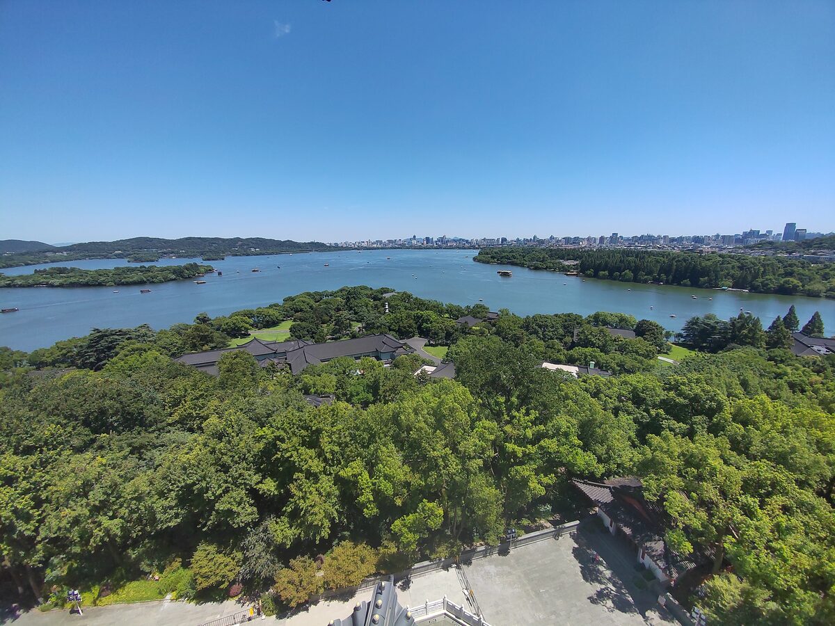 West Lake with wooded islands and the city on the far shore, seen from above on a clear day