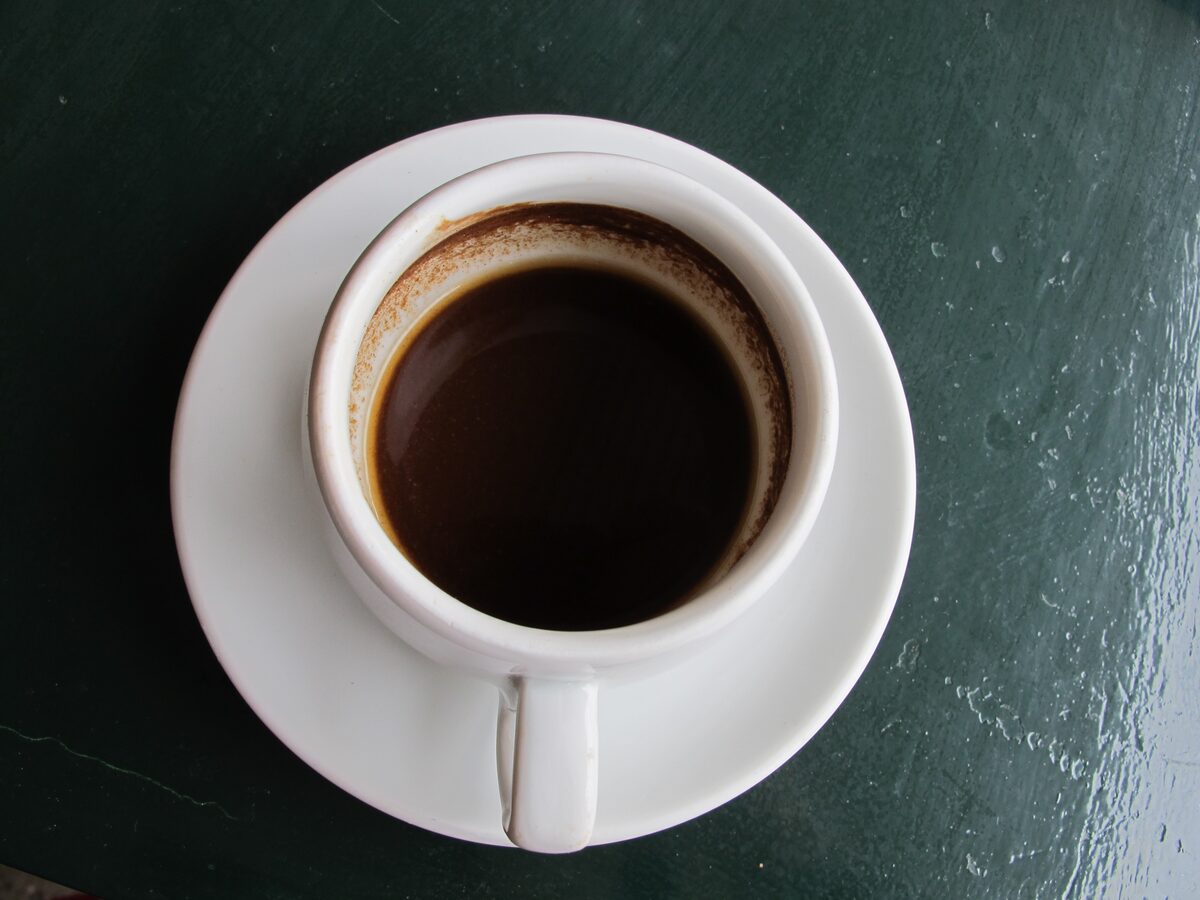 A cup of Greek coffee on a saucer, seen from above