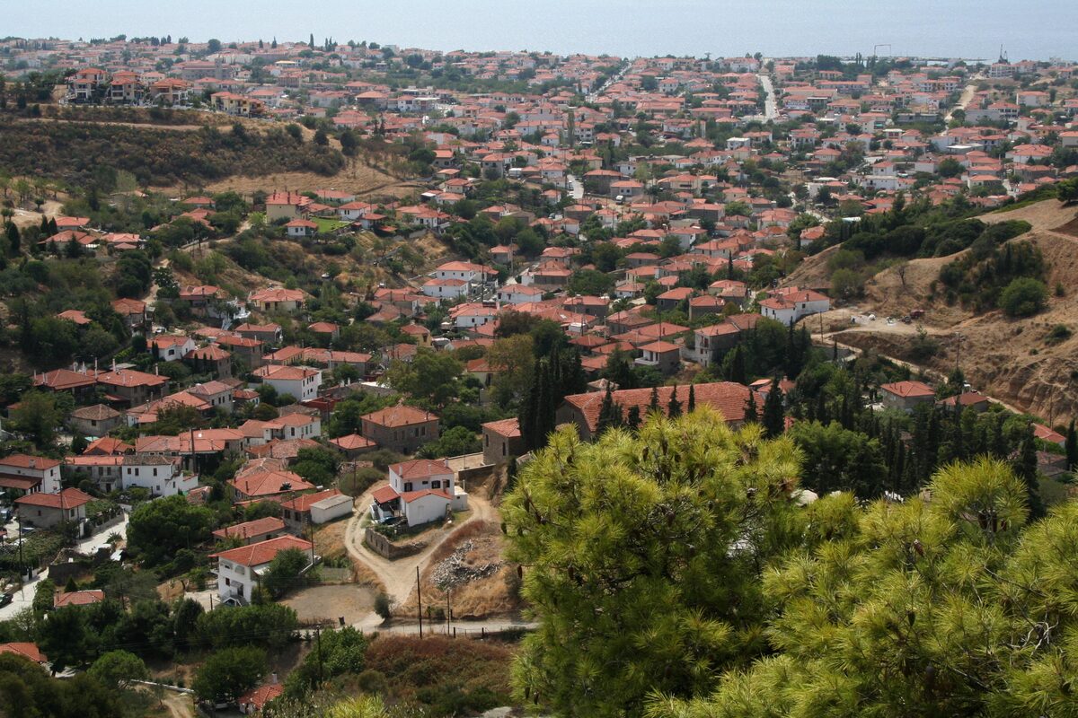 Red-roofed houses of Nikiti spread over a hillside among pines