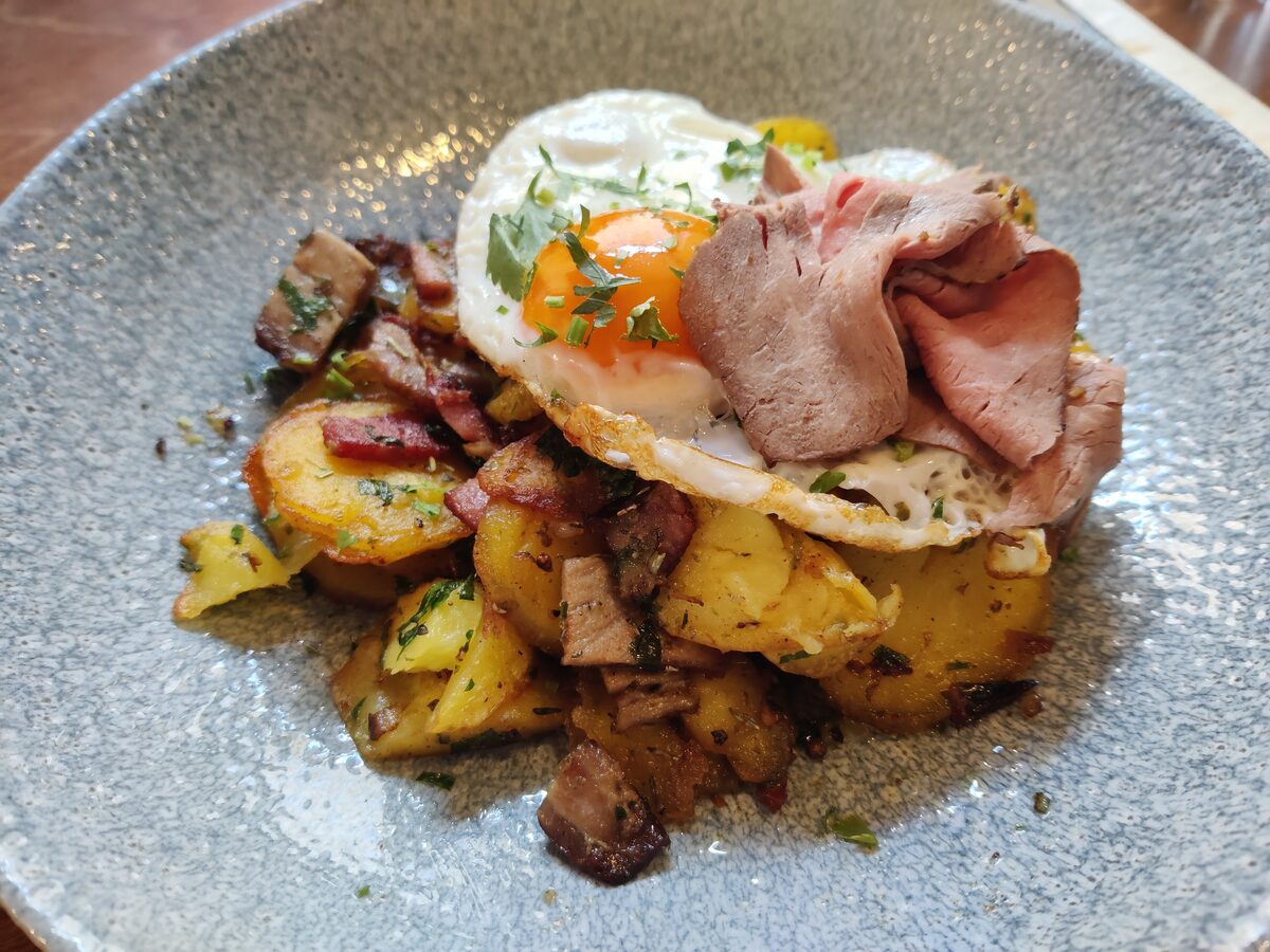 Tiroler Gröstl, fried potatoes with bacon and beef, topped with a fried egg