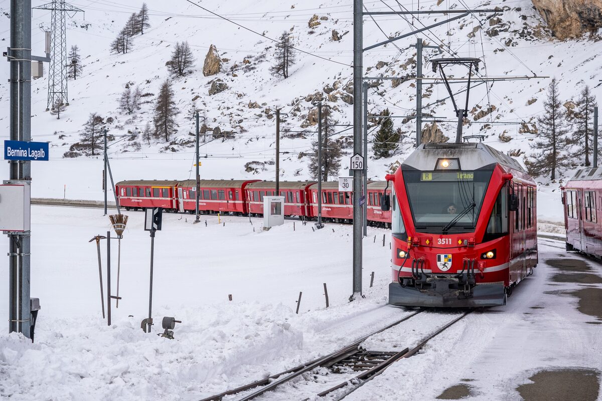 A red RhB Allegra train at Bernina Lagalb station in the snow