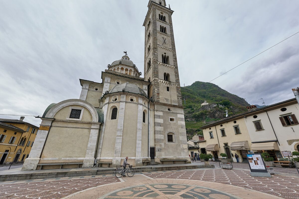 The Sanctuary of the Madonna di Tirano and its tall bell tower on the pale paved square