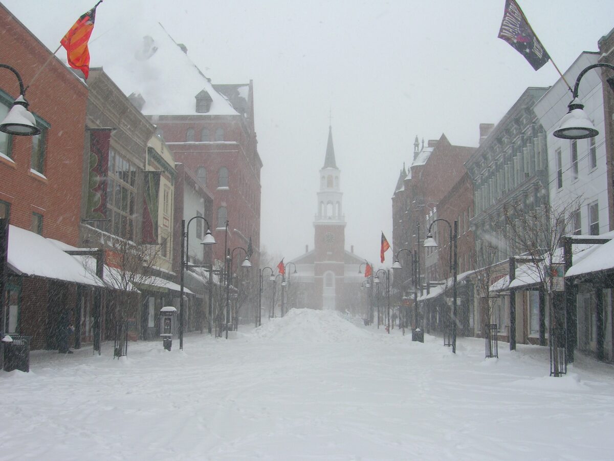 Snowy Church Street in Burlington leading to a white steeple