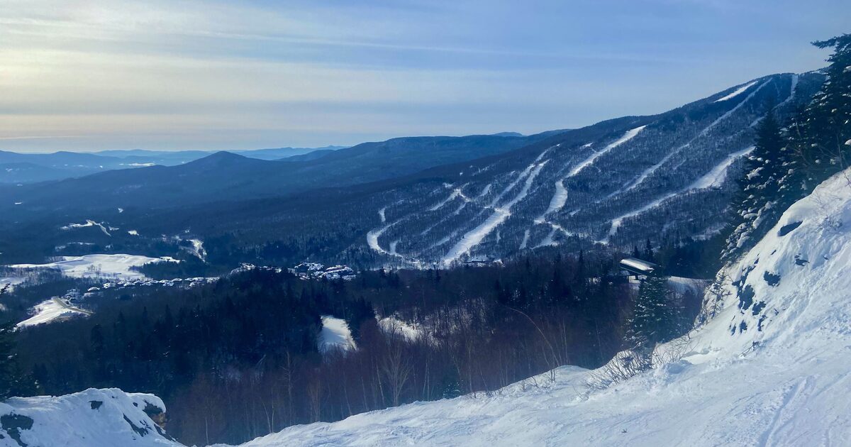 Snowy ski trails on Mount Mansfield seen from a ridge