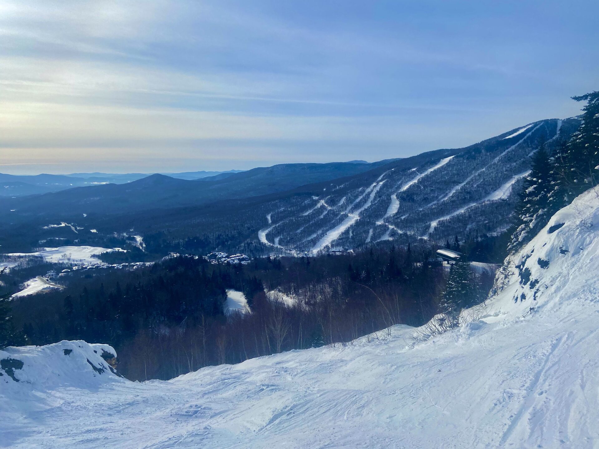 Snowy ski trails on Mount Mansfield seen from a ridge