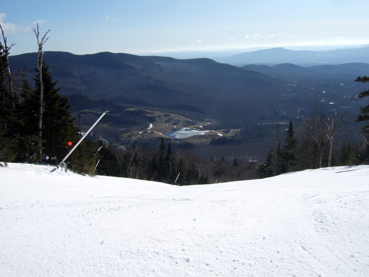 Snowy trail crest above the Stowe valley and distant hills