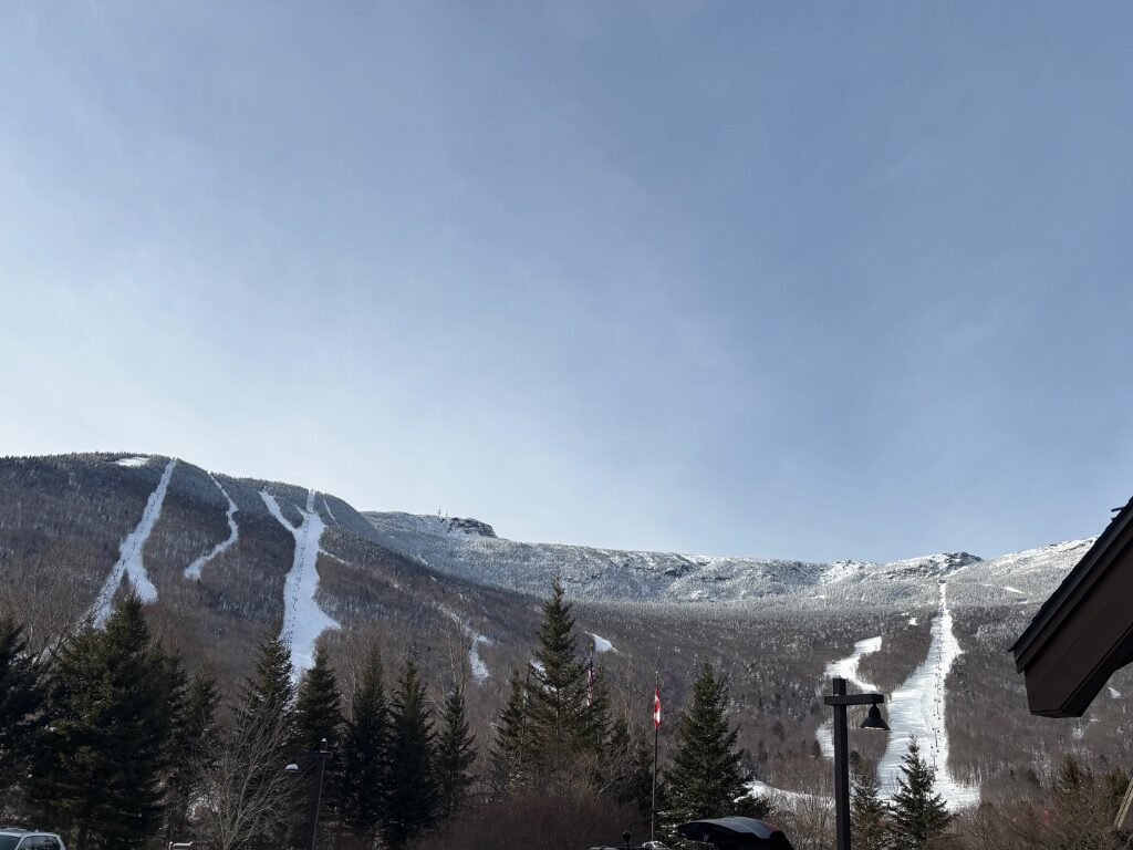 Mount Mansfield's snowy trails seen from the base area lodges