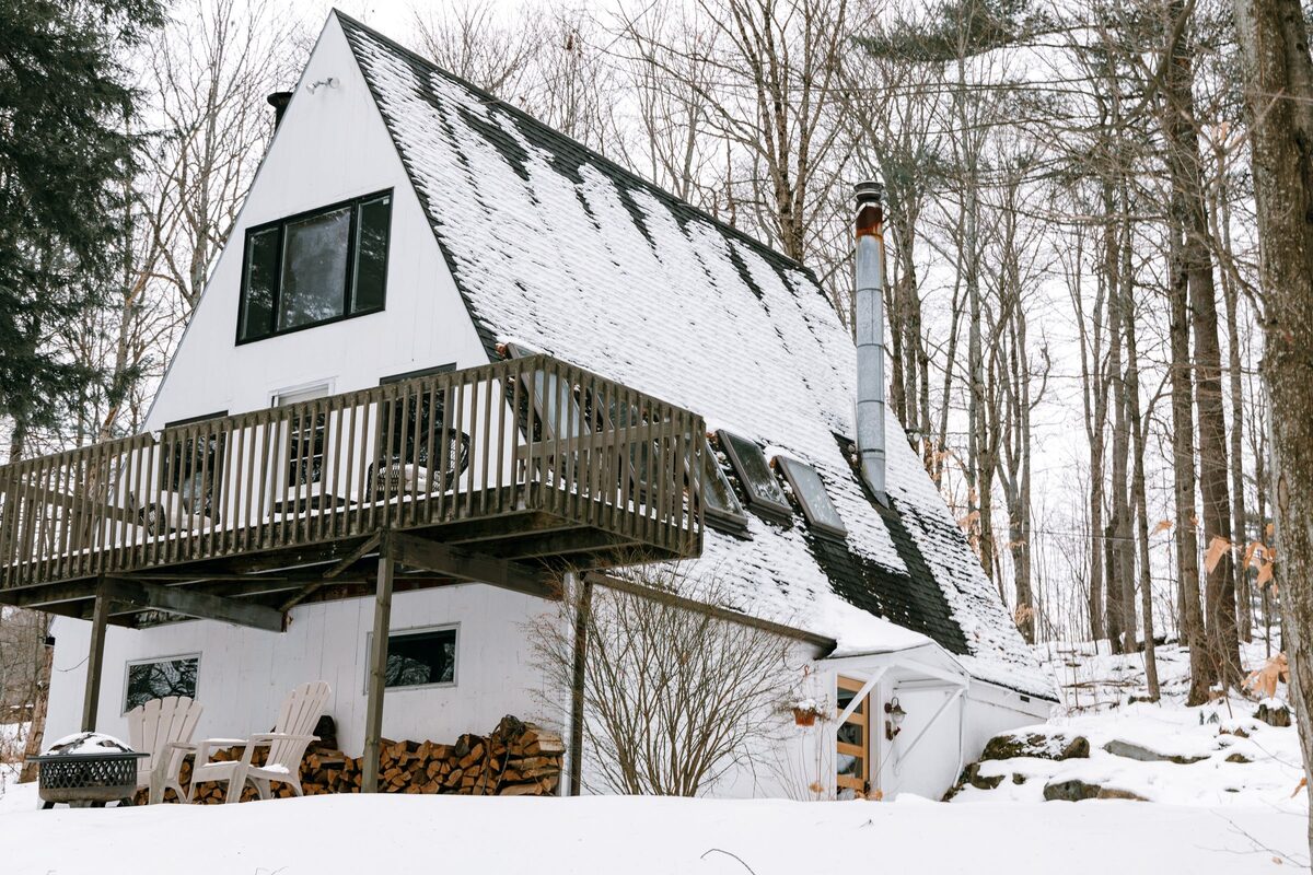 A-frame cabin among snowy woods in Stowe, Vermont