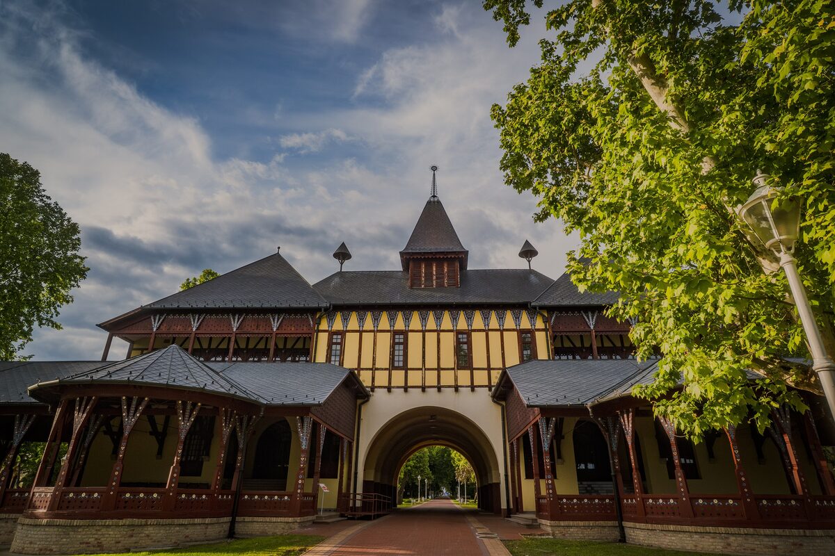 The half-timbered Grand Terrace at Palić with its arched gateway and carved wooden verandas, framed by trees