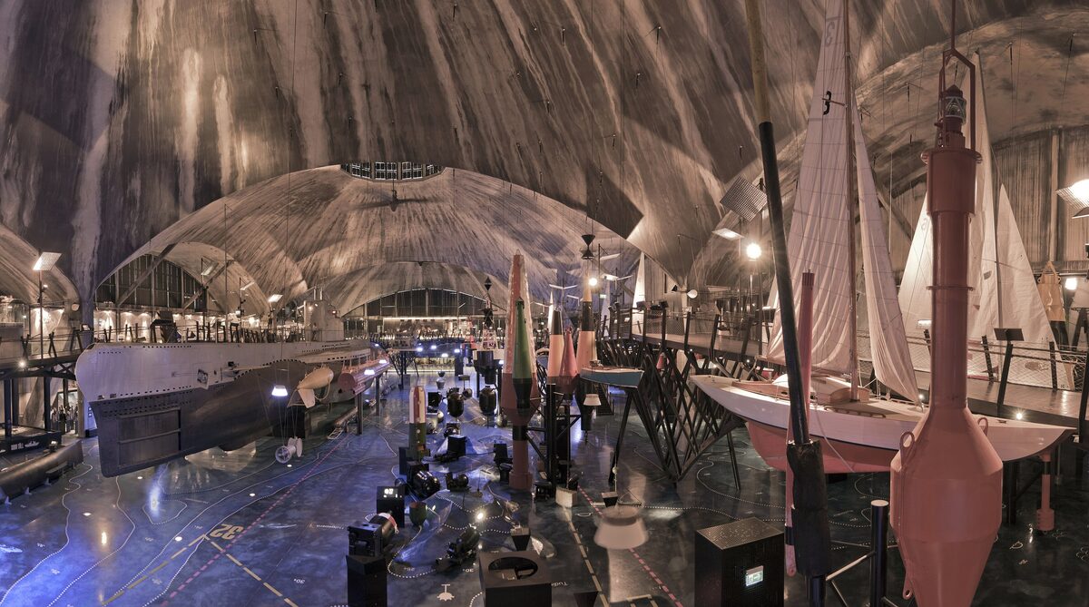 Wooden-vaulted seaplane hangar of the Seaplane Harbour museum with historic wooden boats inside