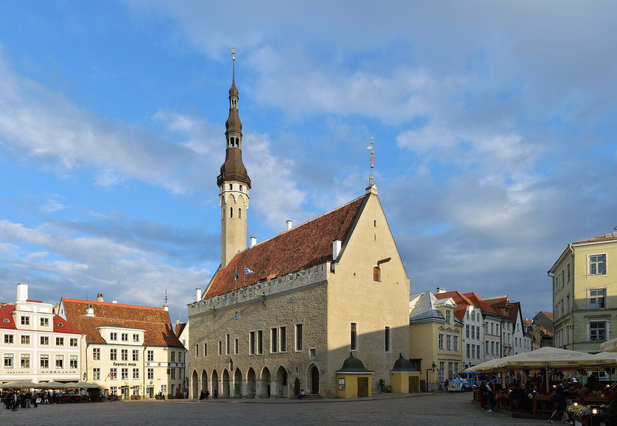 The Gothic Town Hall with its tall spire and the pale yellow facade on Town Hall Square