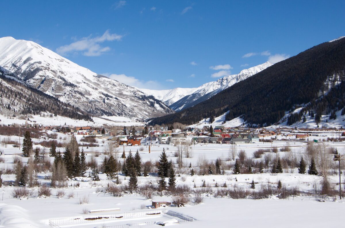 Silverton in snow, with white mountains above the valley town