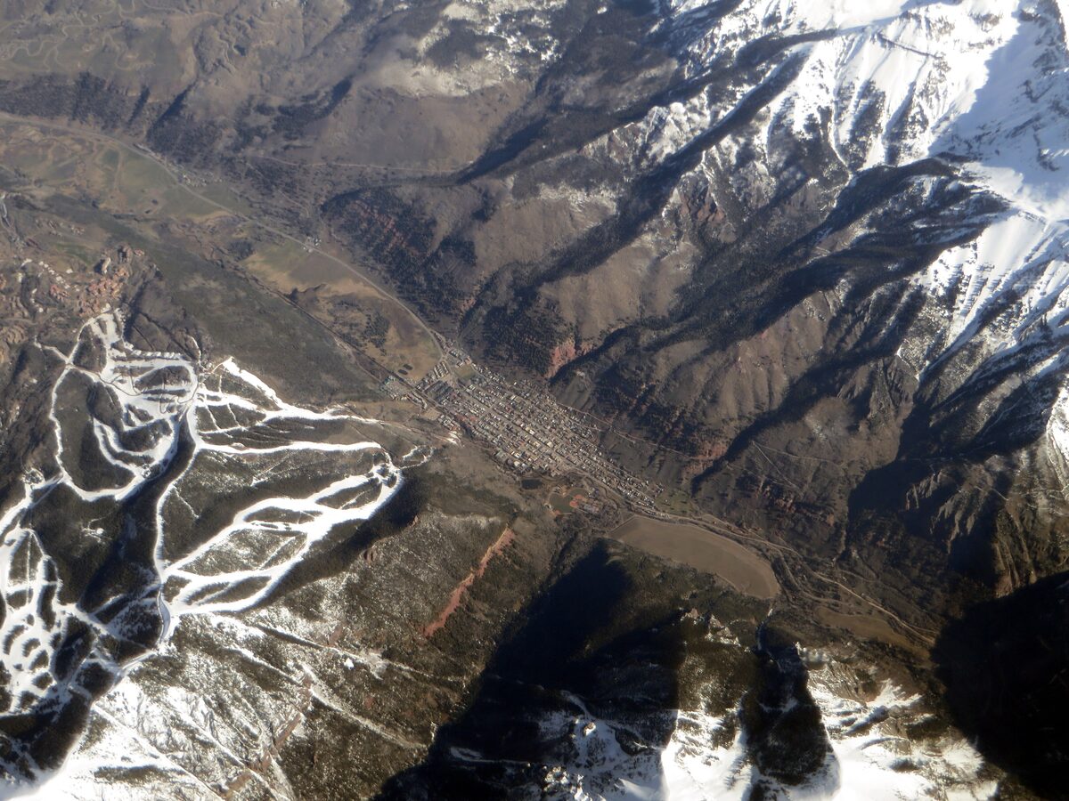 Aerial view of Telluride in its box canyon, with ski runs beside it