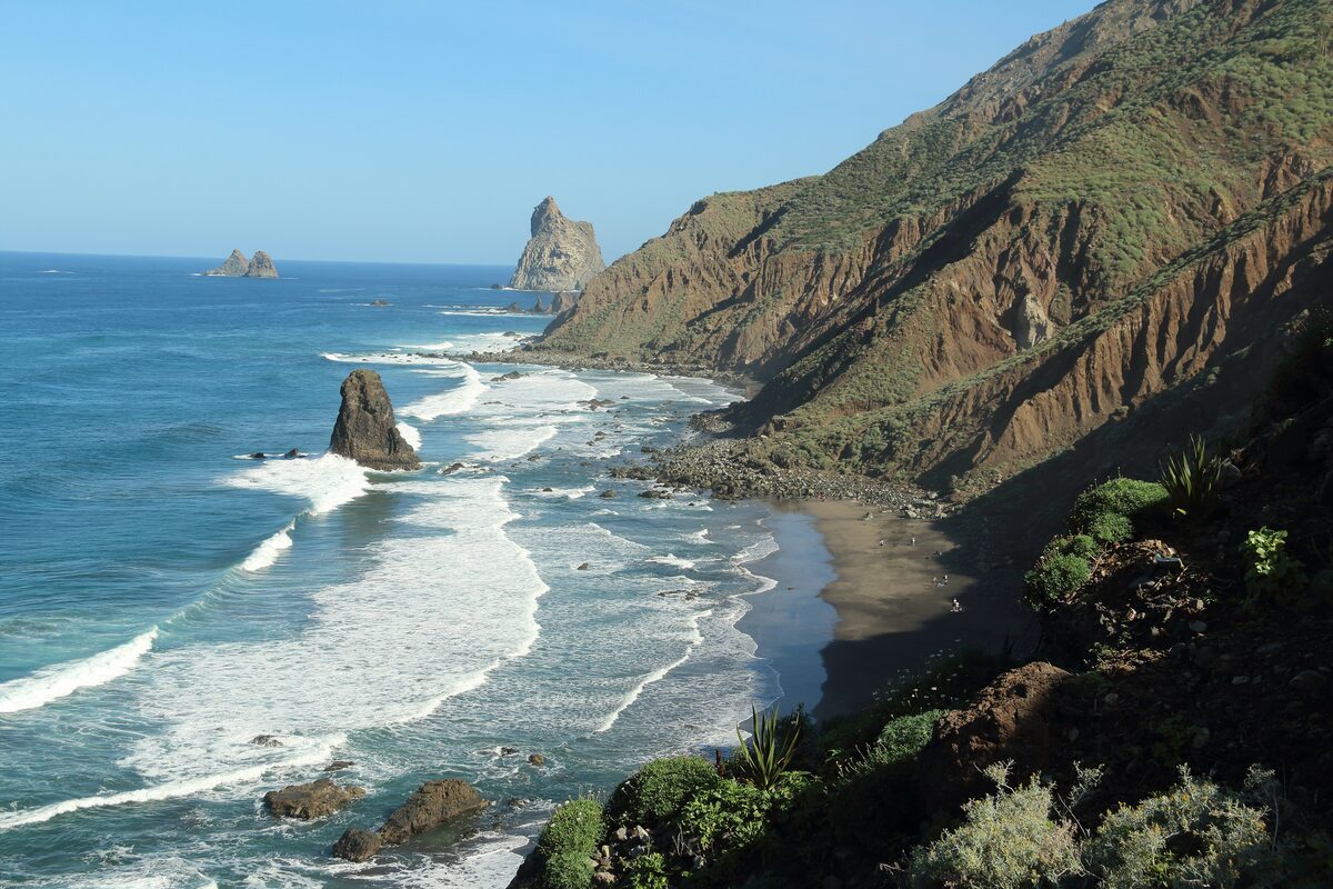 The Benijo coast in Anaga, with steep cliffs, surf, a dark-sand cove and rock stacks