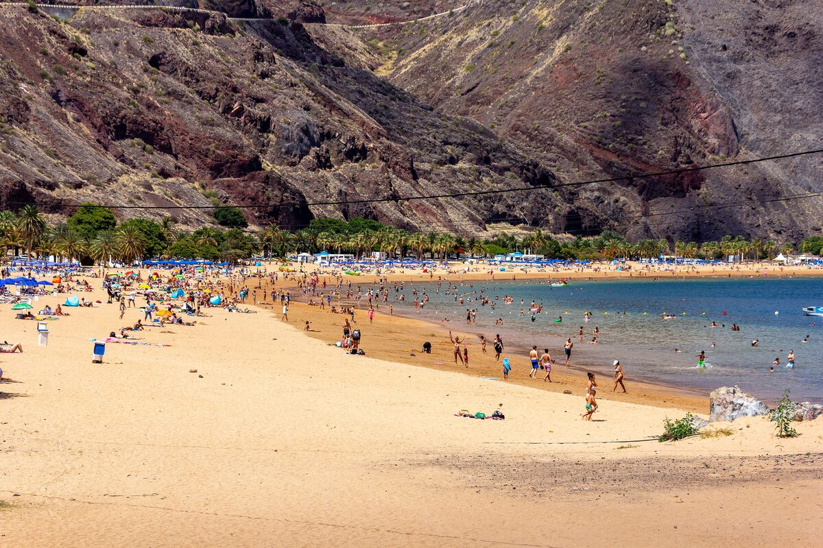 Las Teresitas beach with golden sand and bathers in the shallow sea