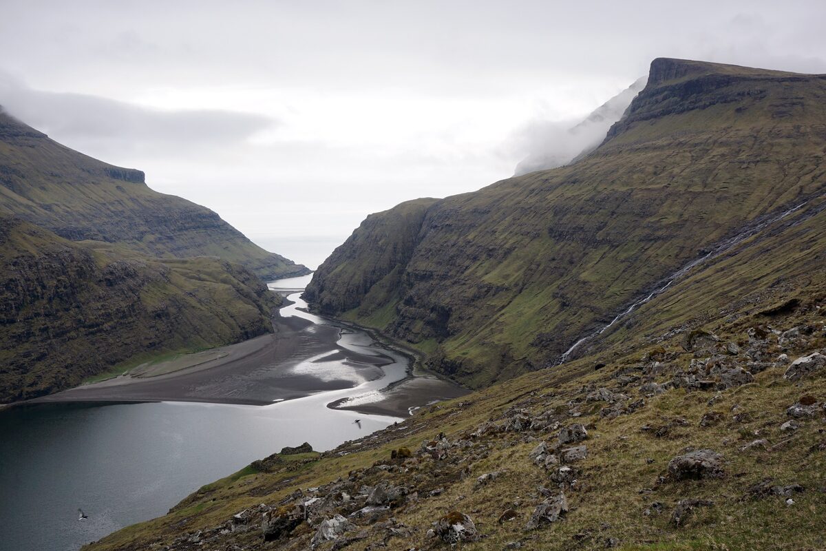The sandy inlet and river at Saksun, between steep green mountains