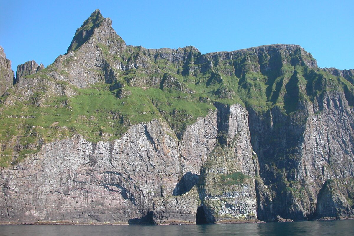 The Vestmannabjørgini sea cliffs, dark ridges above the water