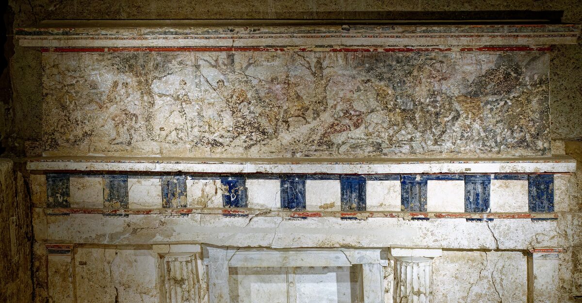 The painted facade of a royal Macedonian tomb at Vergina, with a faded hunting frieze above a band of blue and white decoration