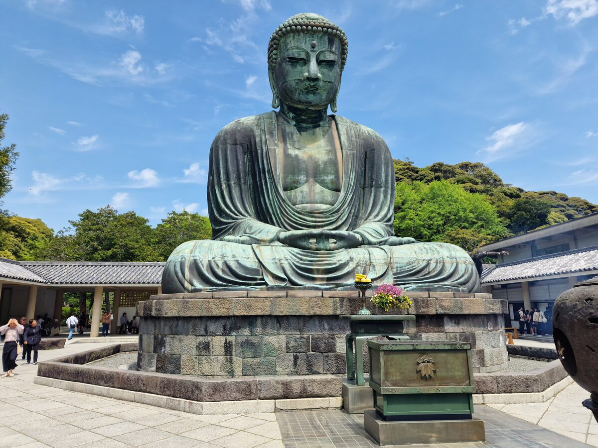 The bronze Great Buddha of Kamakura seated outdoors in the grounds of Kotoku-in temple