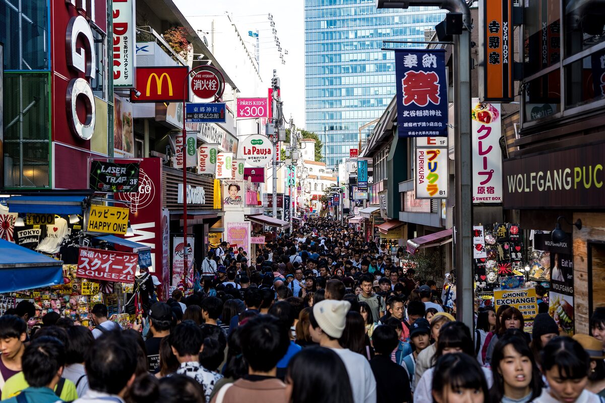 A crowded Takeshita Street in Harajuku, lined with shops, crepe stands and bright signs