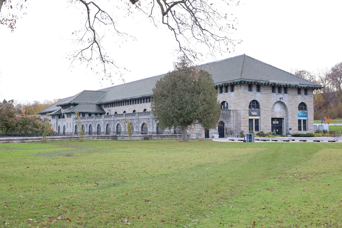 The stone Niagara Parks Power Station building across a lawn under a gray sky