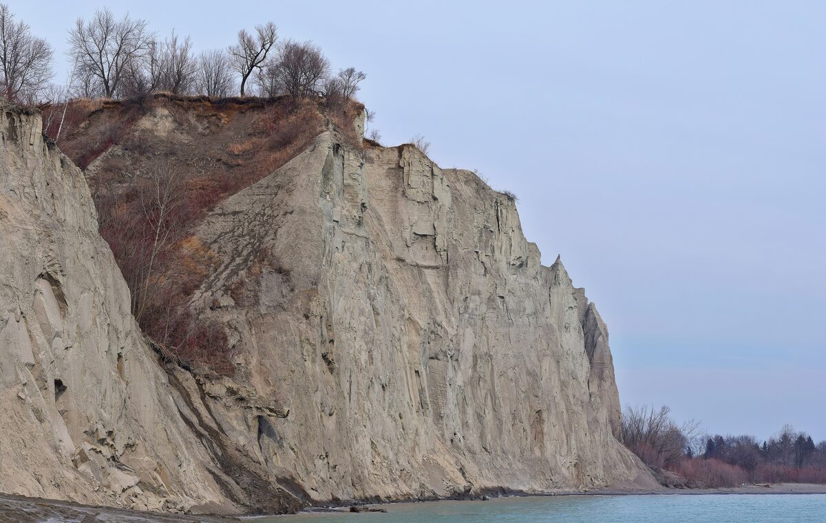 The pale clay cliffs of the Scarborough Bluffs dropping to the shore of Lake Ontario