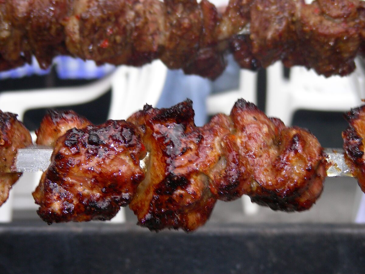 Close-up of glazed pork souvlaki skewers grilling at the Taste of the Danforth street festival