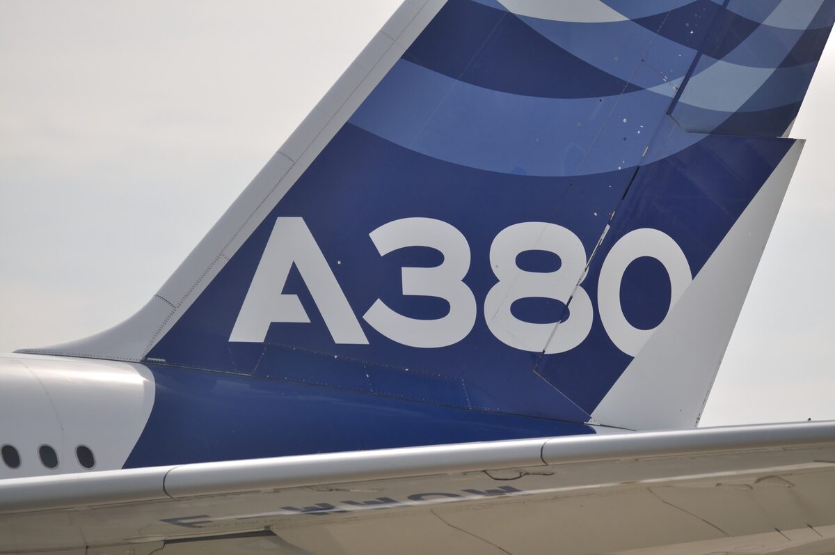 The tail fin of an Airbus A380 with its blue and white logo, photographed at Toulouse Blagnac airport