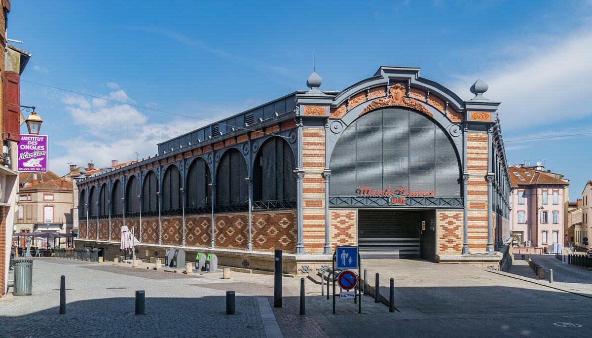 The arched iron-and-brick front of the covered market in Albi, with decorative brickwork