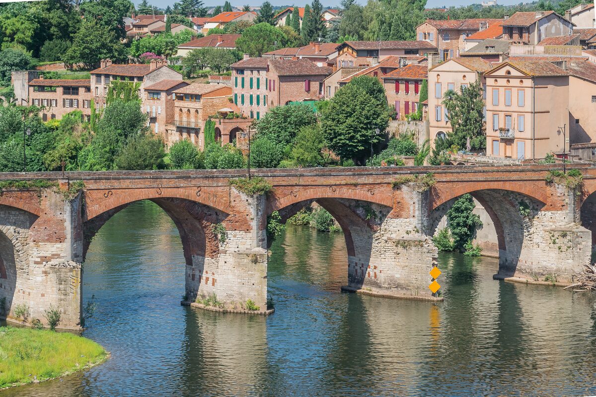 The old brick bridge over the Tarn in Albi, with the old town's houses rising above the river