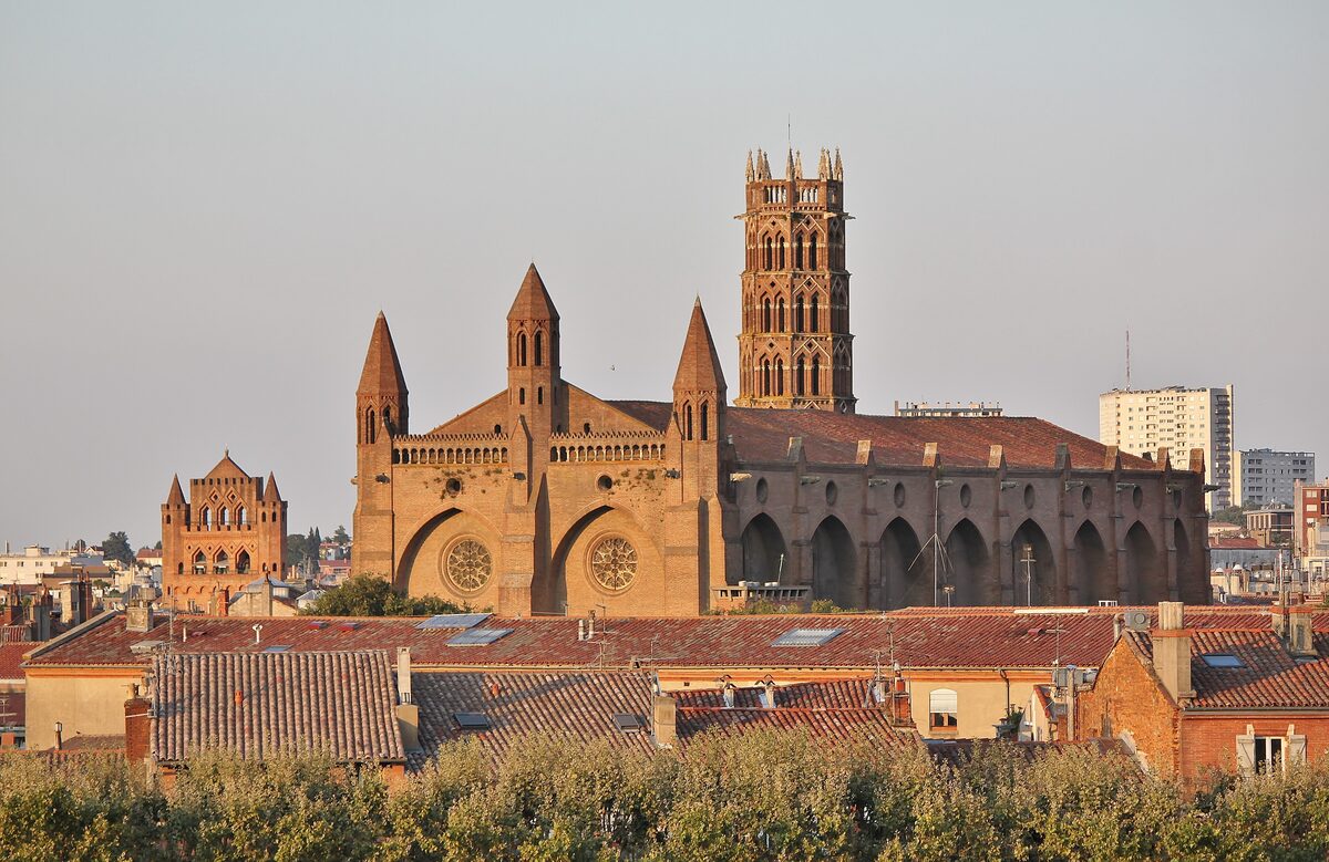 The brick Jacobins church and its tall bell tower rising above the rooftops of Toulouse