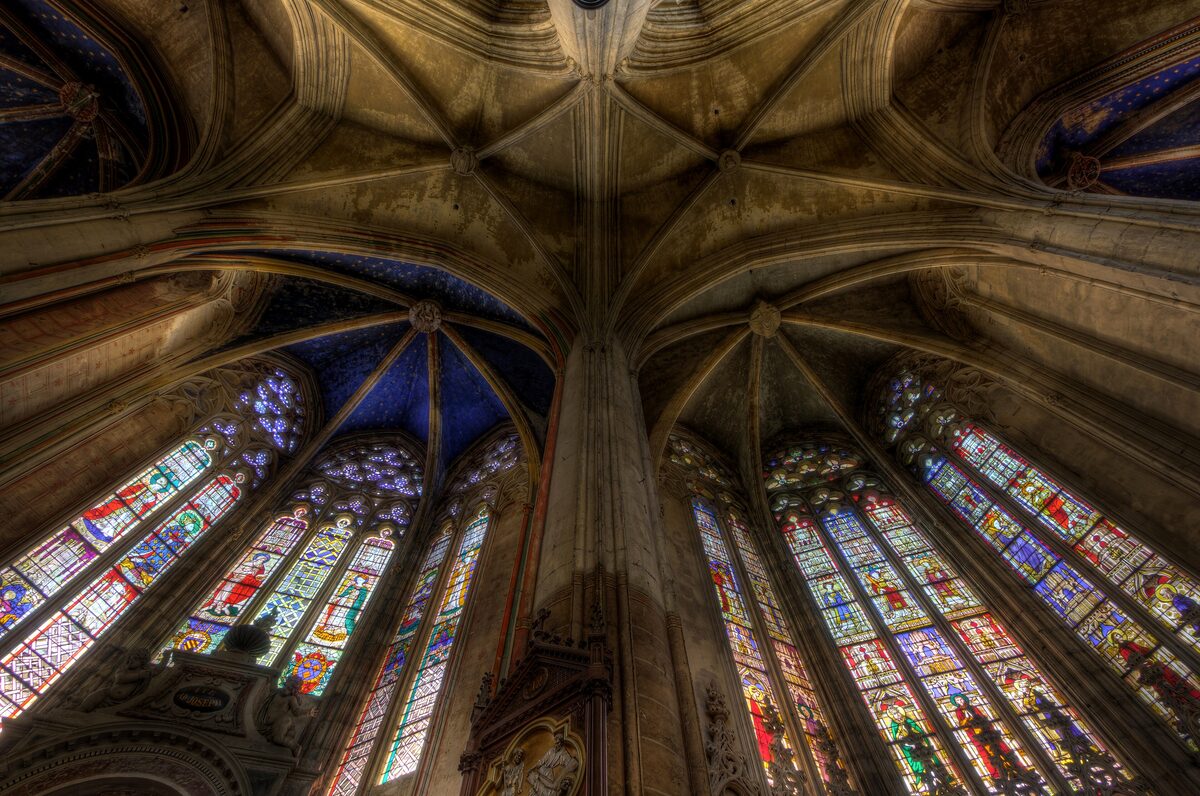 Ribbed stone vaults and stained-glass windows in the ambulatory of Saint-Étienne cathedral in Toulouse