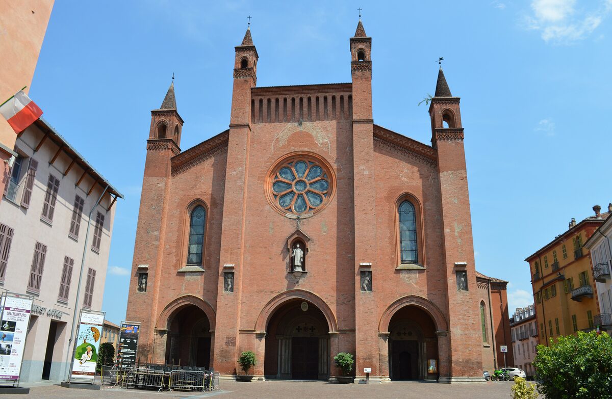 The brick facade and rose window of Alba Cathedral