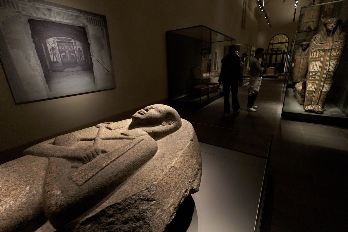 Stone sarcophagus and mummy cases in the Egyptian Museum galleries