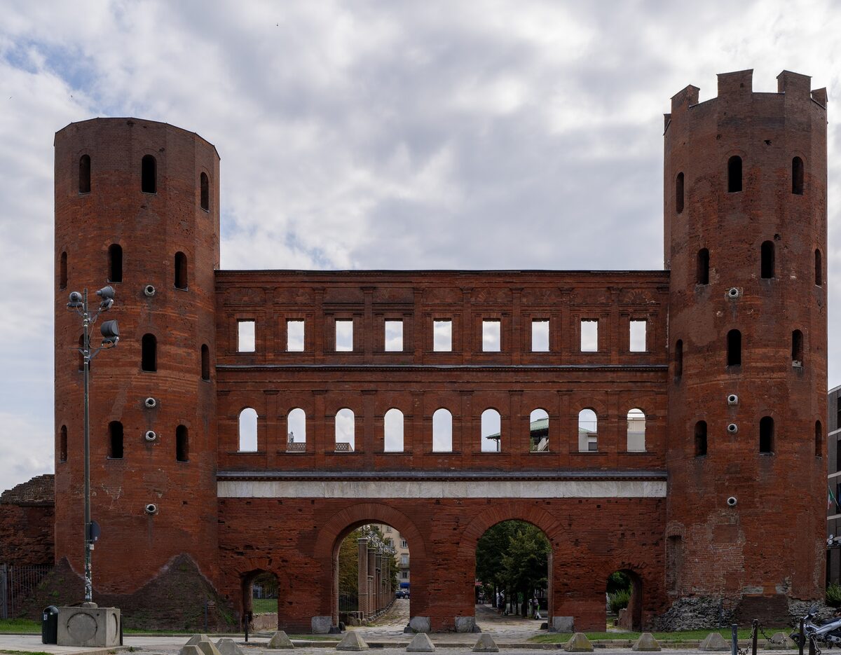 The two brick towers and arch of the Porta Palatina Roman gate