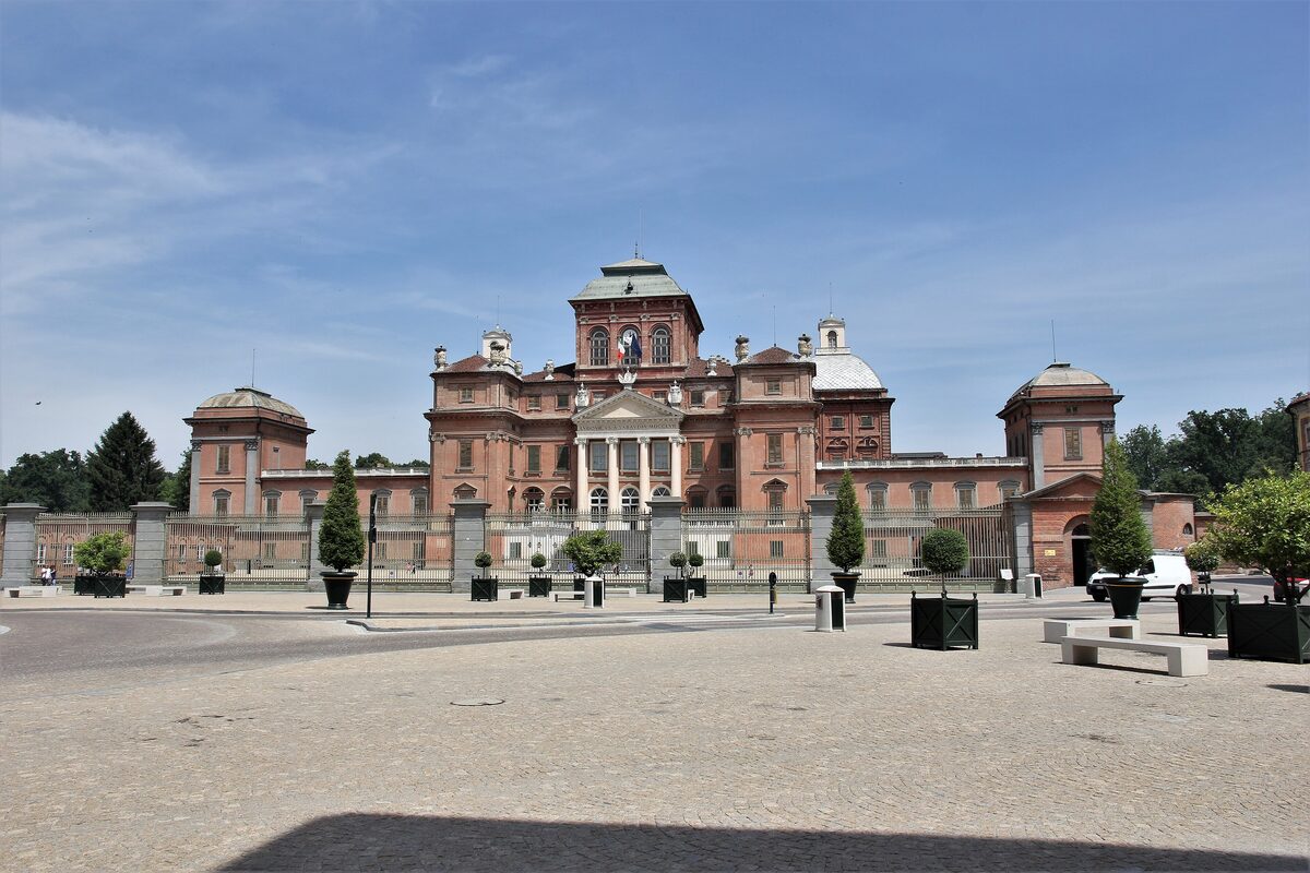 Racconigi Castle, a pink-brick palace behind its iron fence