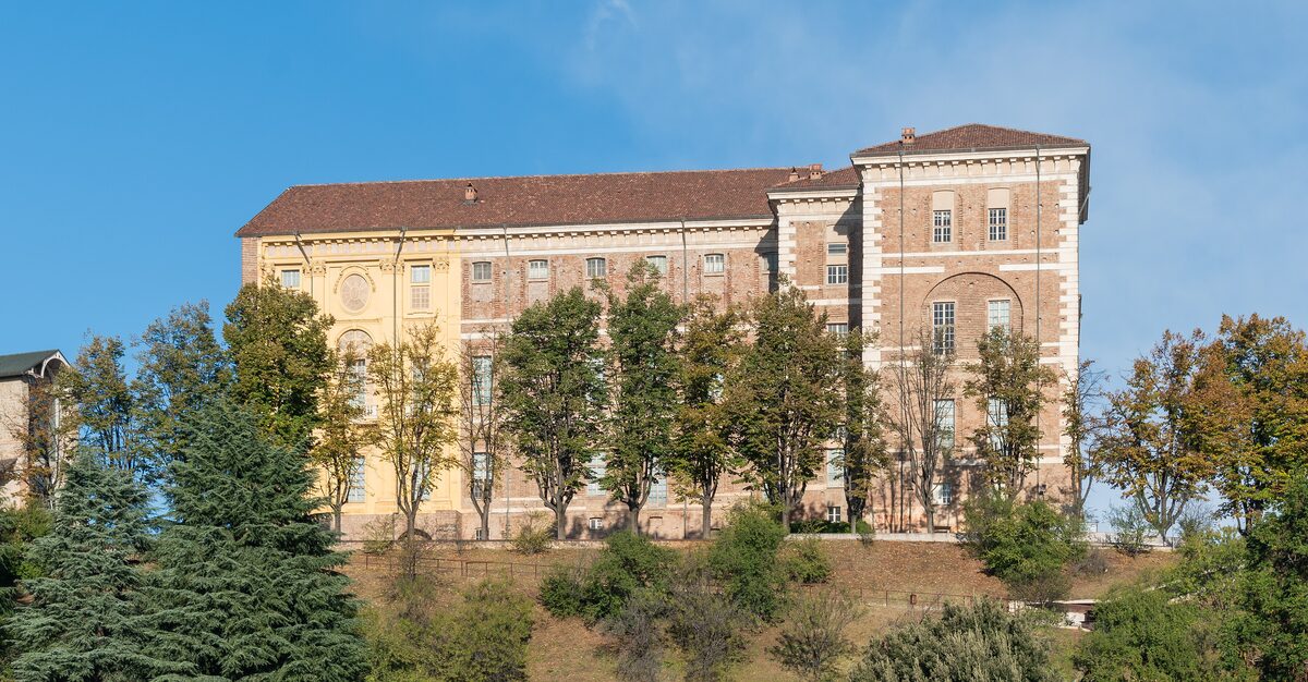 The Castle of Rivoli, a long brick palace with trees in front