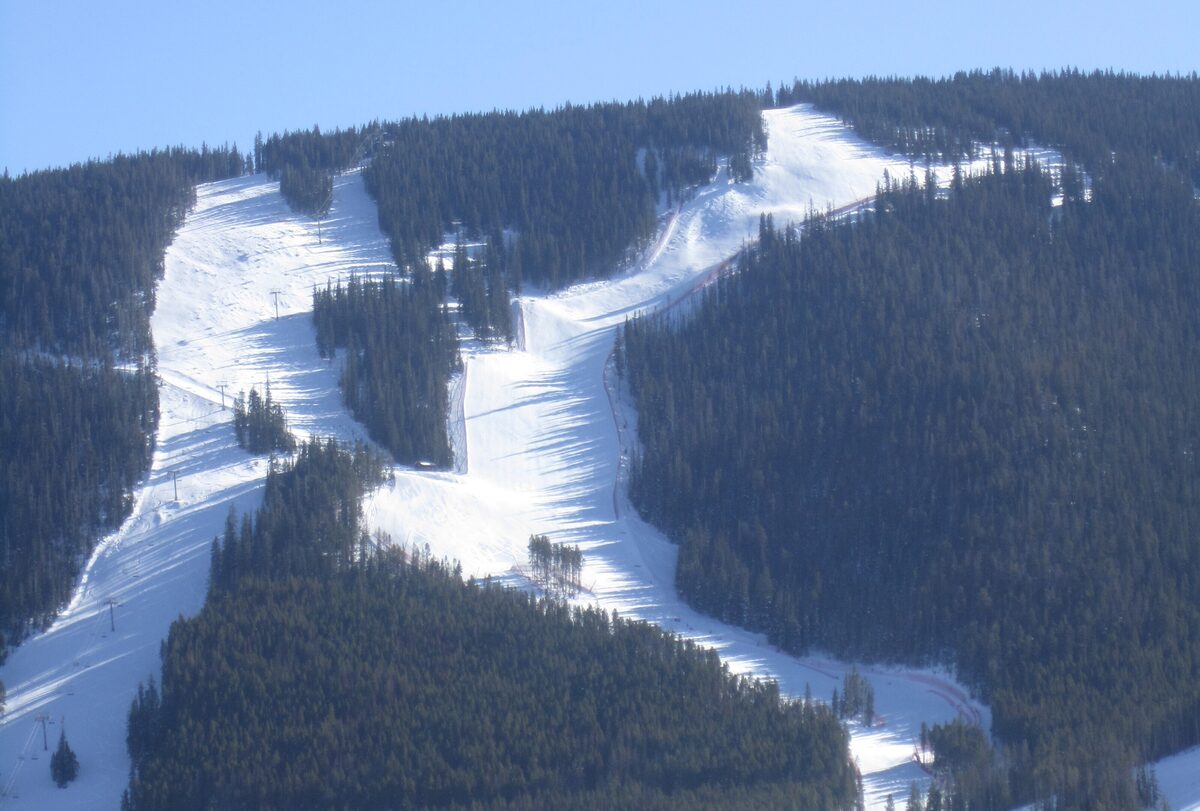 The Birds of Prey World Cup downhill course on Beaver Creek, snow-packed racing lanes between dark forest