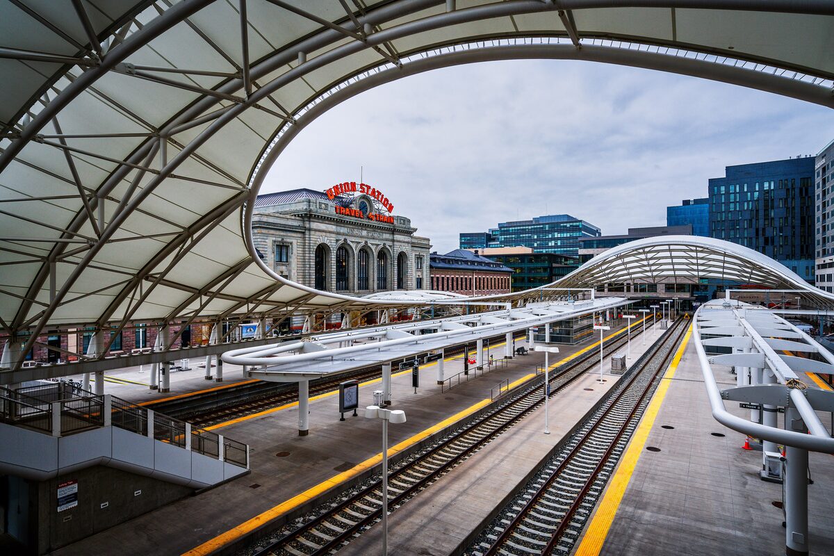 The curved train-shed canopy at Denver Union Station, with the historic station building beyond