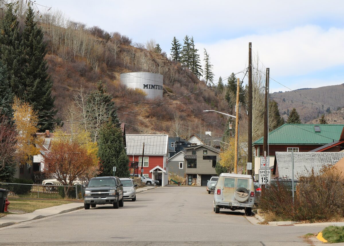 Pine Street in Minturn, with the town water tank marked MINTURN on the hill above the houses