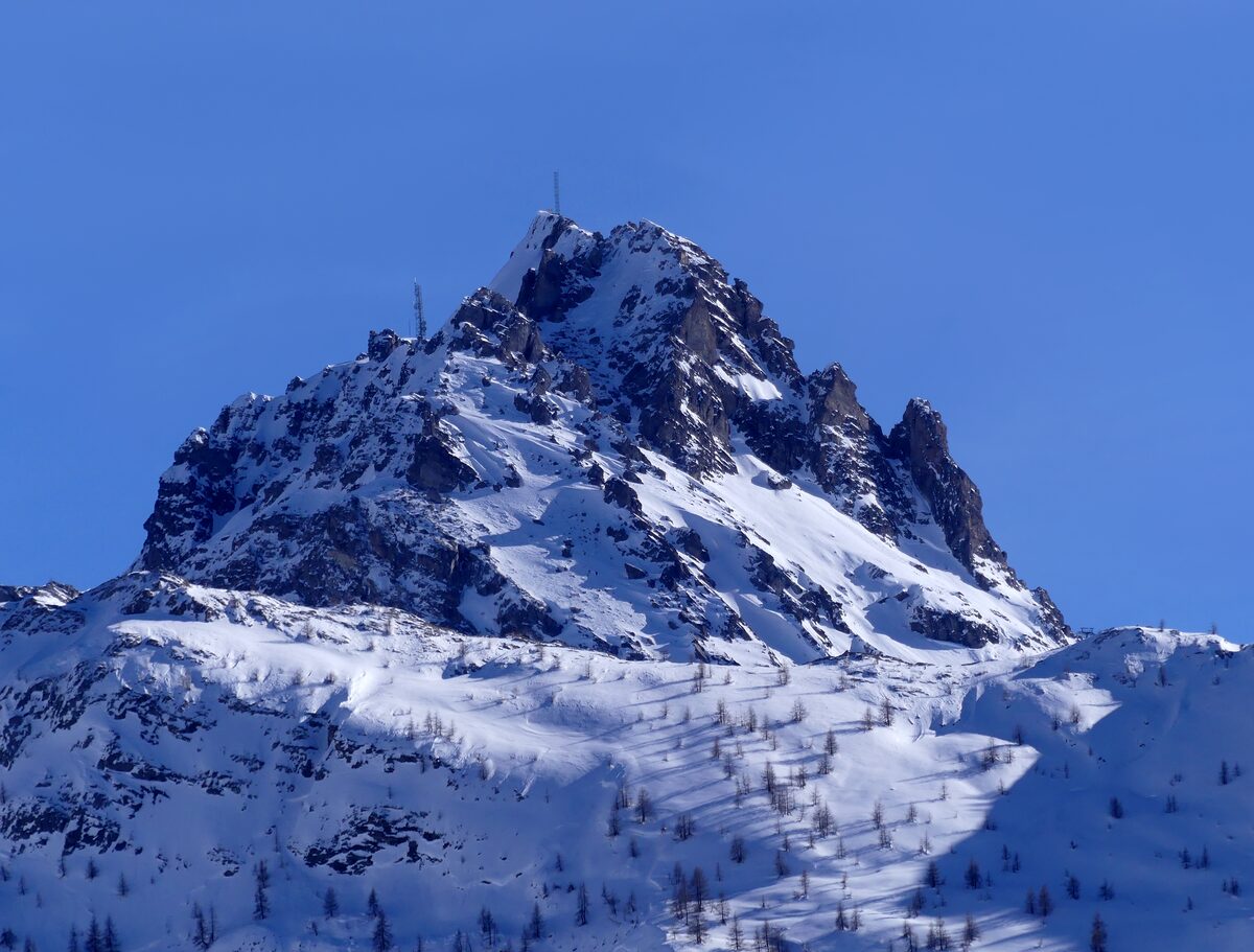 The snowy rock of Bellevarde against a deep blue sky, seen from Tignes 1800