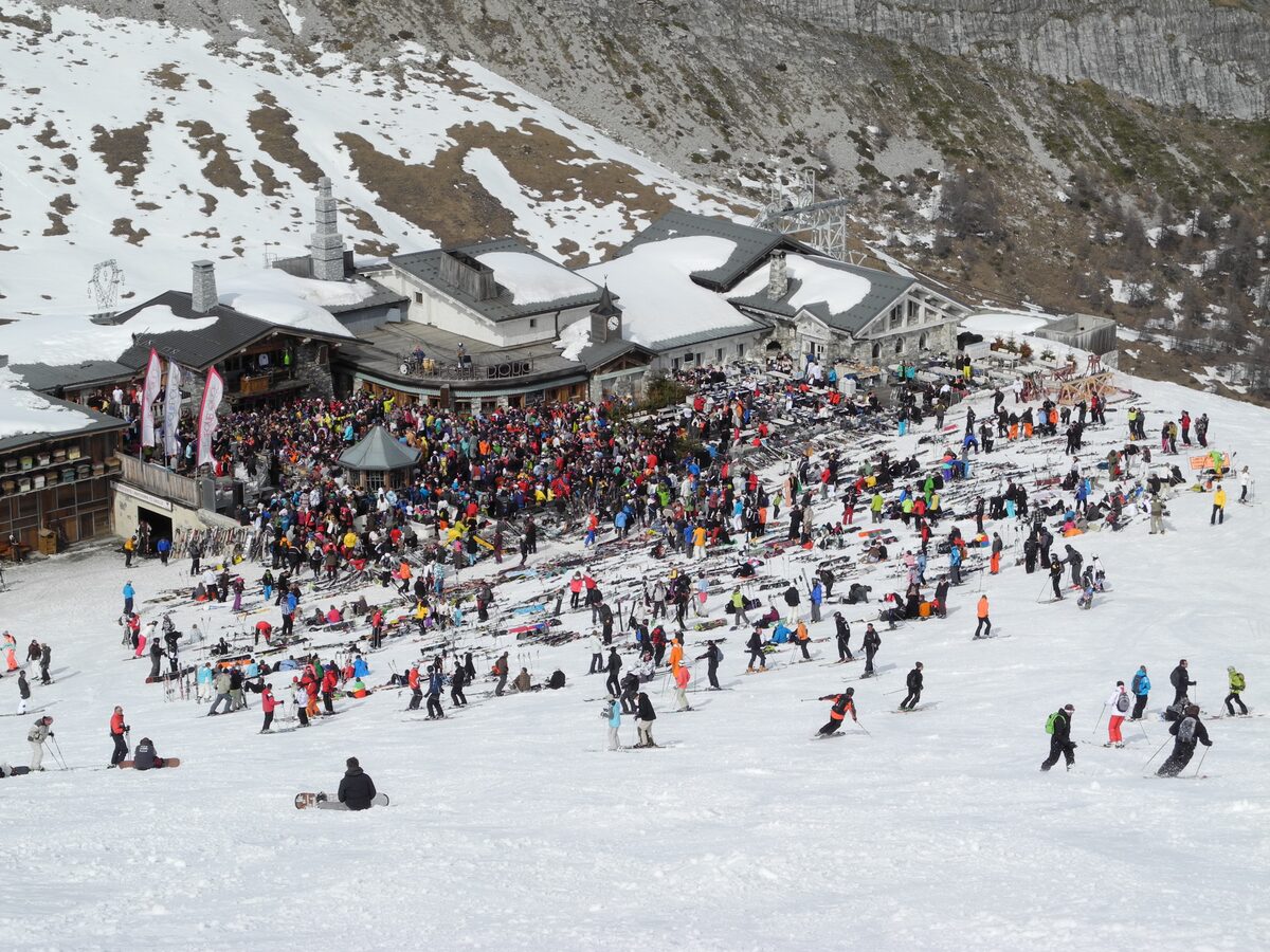 A crowd of skiers and snowboarders on the snow in front of La Folie Douce, Val d'Isère